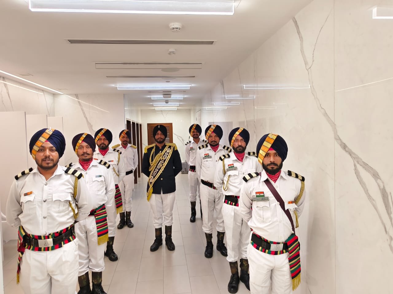 Band members in white uniform standing in formation