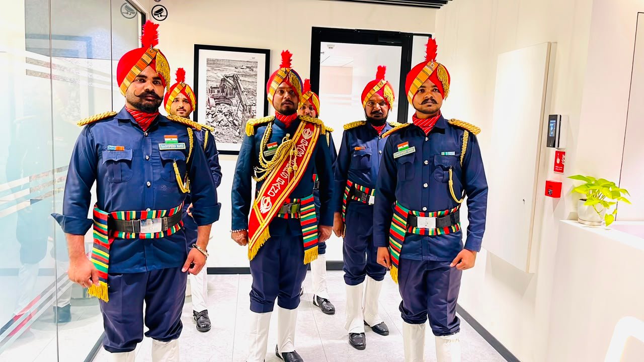 Three band members in navy uniform indoors